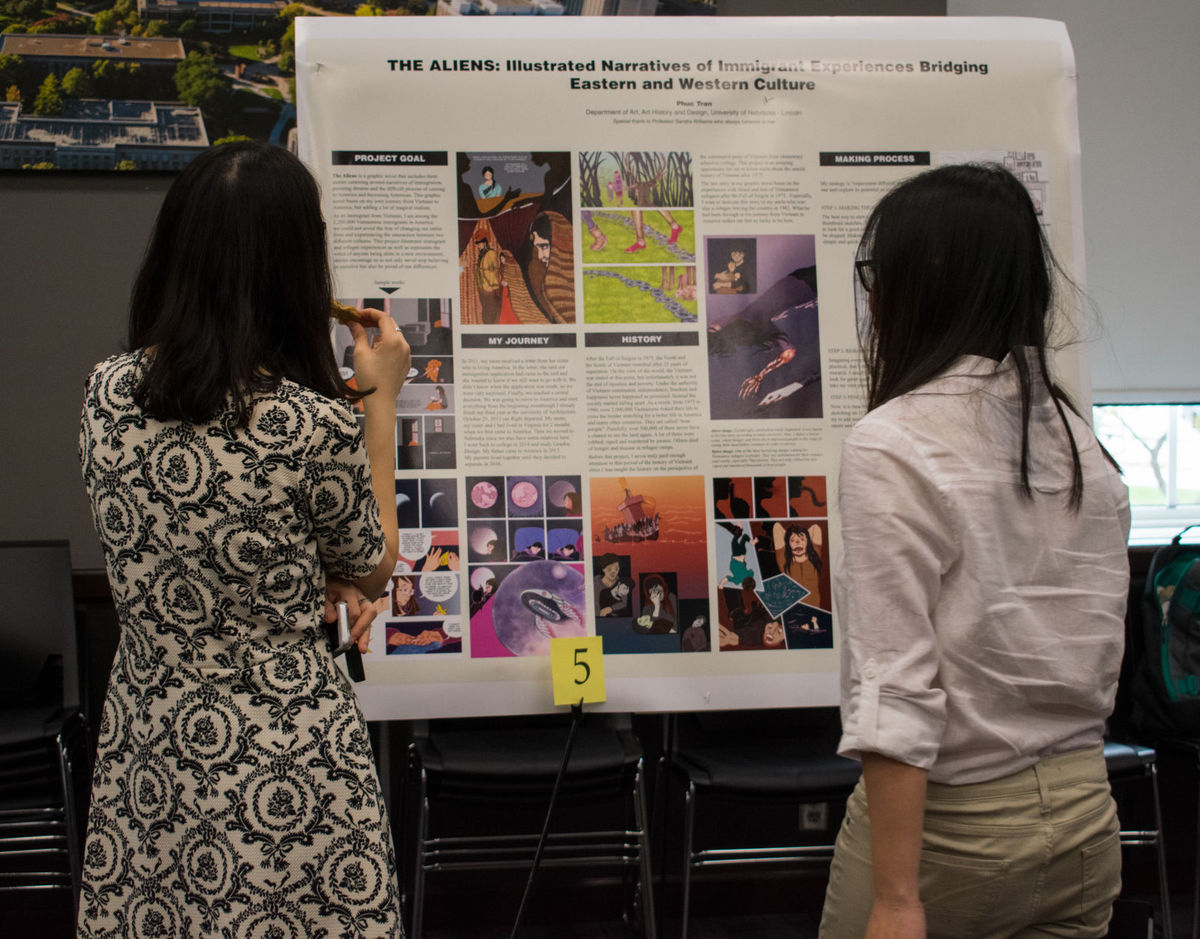 Photo Credit: Female students in front of a research poster