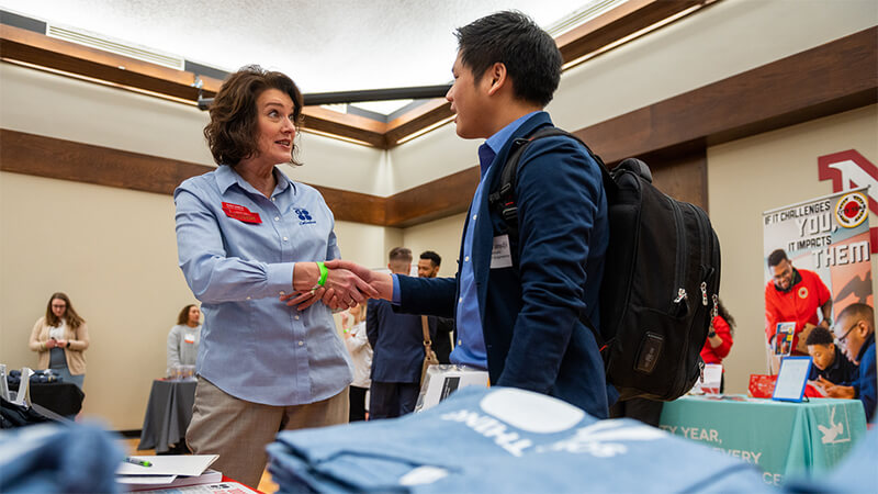 Student meets with corporate representative at UNL Career Fair.