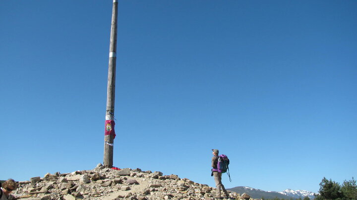 a pilgrim at Cruz de Ferro along the Camino