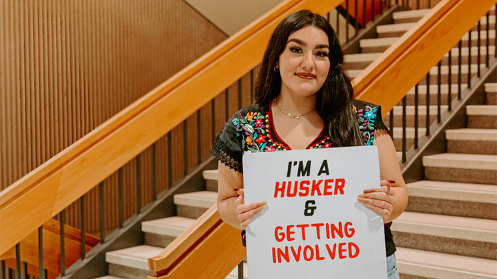 Dalilah Valdez holding a sign reading, 